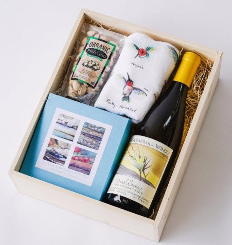 Santa Barbara Simplicity Gift Box | Food For Net A wooden box with wine, a tea towel and some other items.