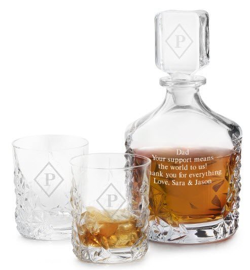 Sculpture Decanter Set | Food For Net Whiskey decanter engraved with a quote, along with two glasses, one containing whiskey.