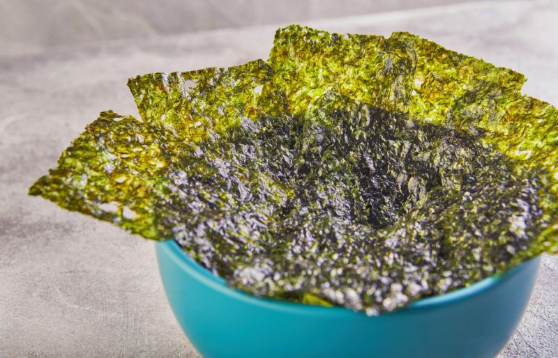 A blue bowl of seaweed