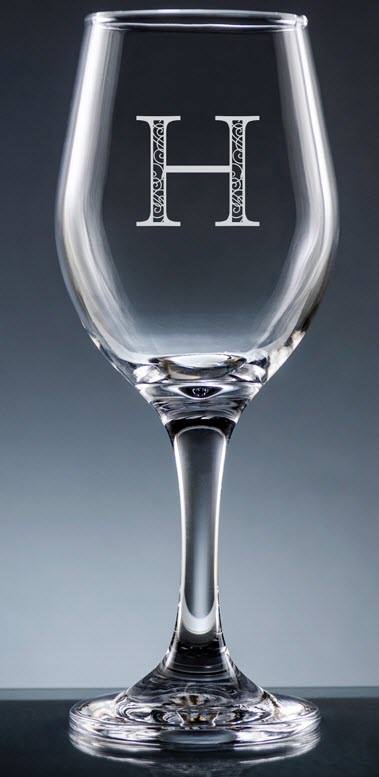 Sencillo Wine Glass With Stem | Food For Net A clear glass with an H stenciled on.