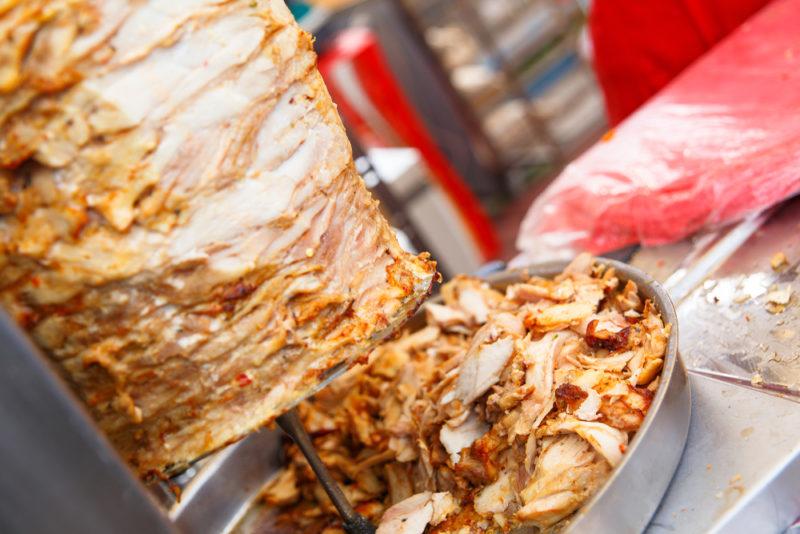 Shawarma on a spit with some meat that has been shaved off underneath