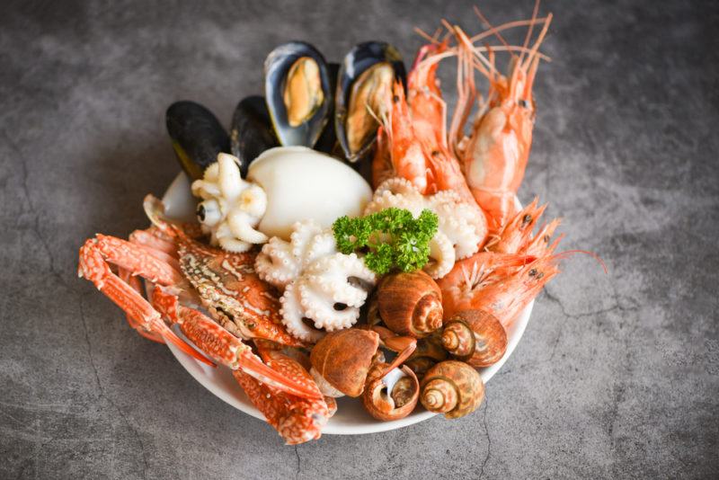 A white bowl with various shellfish