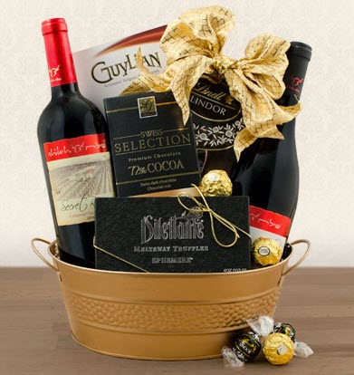 Shiloh Red Wine Duo Gift Basket | Food For Net A bronze basket containing various snacks and 2 bottles of wine.