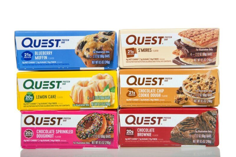 Six boxes containing different flavors of Quest bars