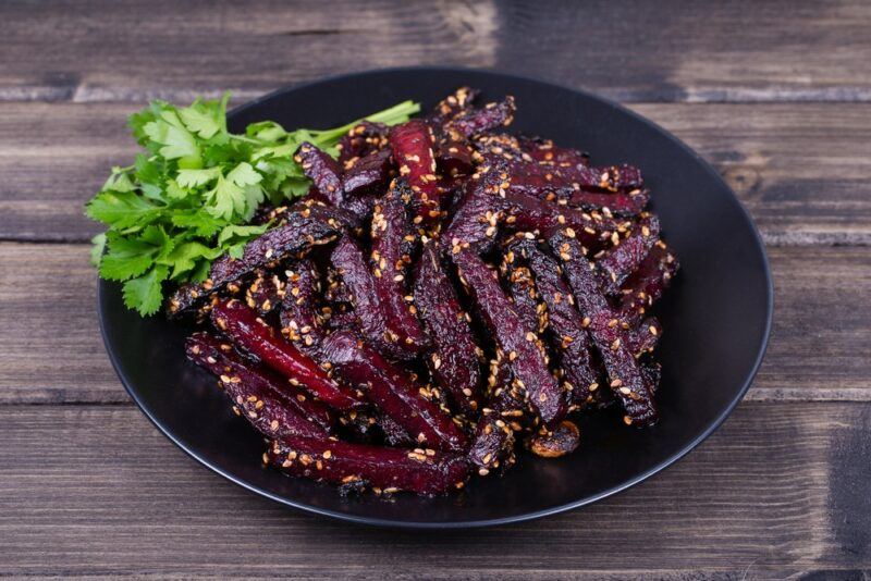 A black dish with beets that have been air fried