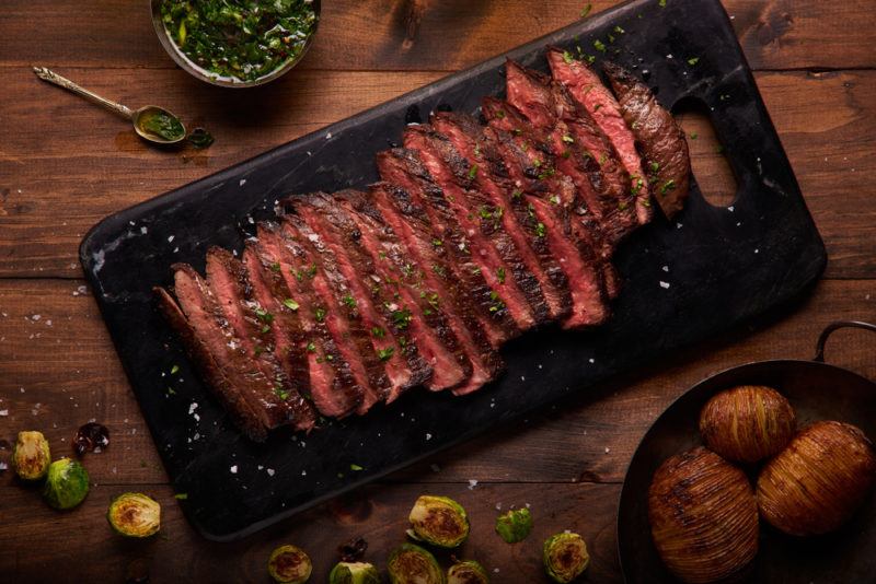 Sliced steak on a black plate