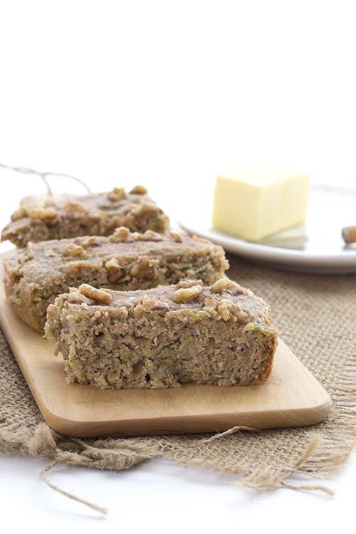 Thick slices of slow cooker zucchini bread on a wooden board