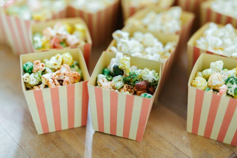 Small containers filled with seasoned popcorn