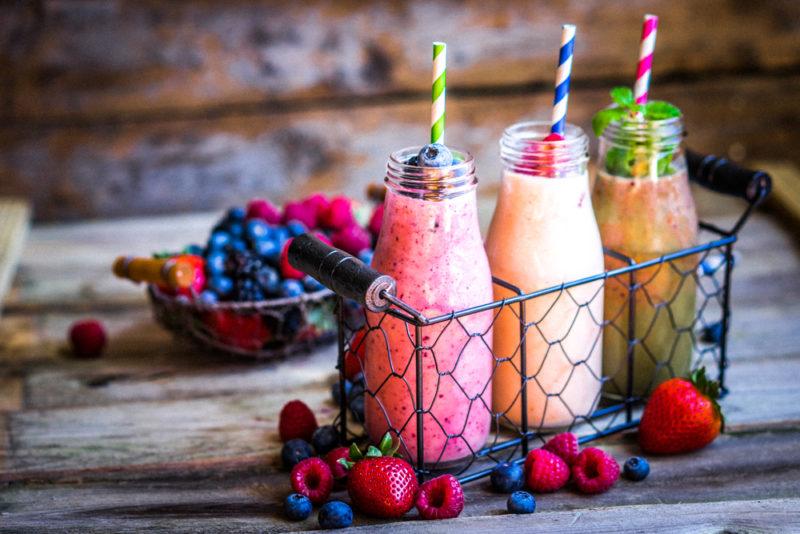 A collection of three smoothies in a wire cage