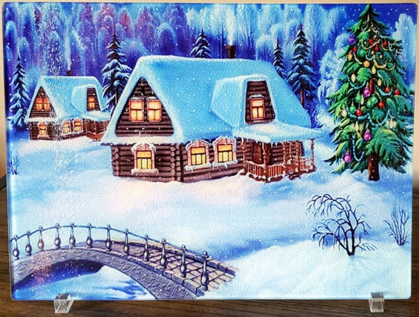 Snowy-Christmas-Glass-Cutting-Board | Food For Net Snowy scene with cottages and a Christmas tree.