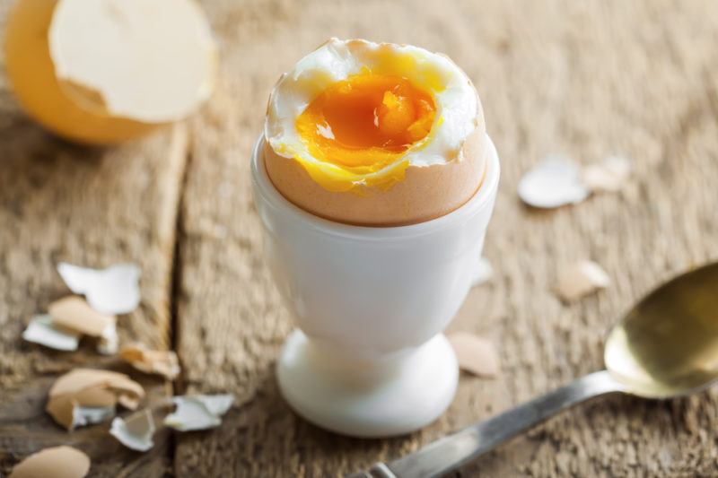 An egg cup containing a soft boiled egg