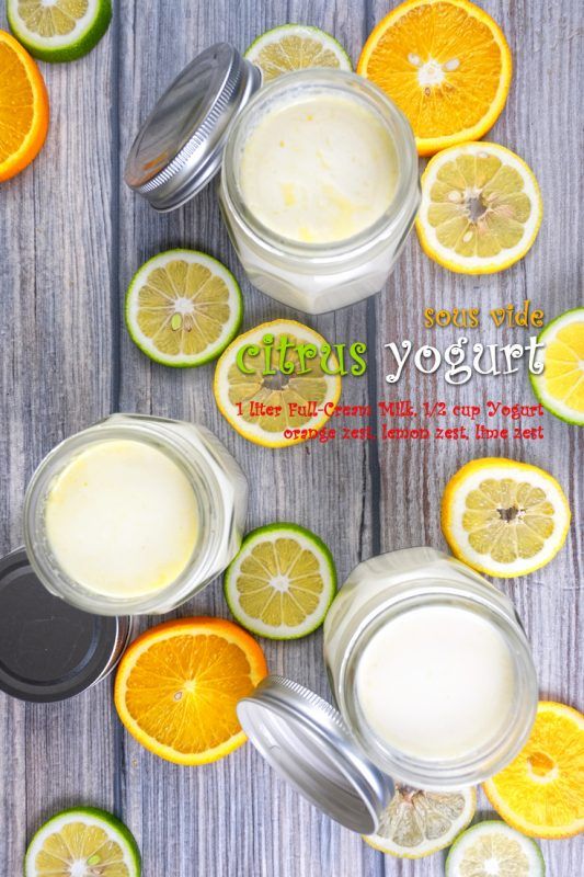 A wooden table with pots of citrus yogurt andslices of lemons, limes, and oranges