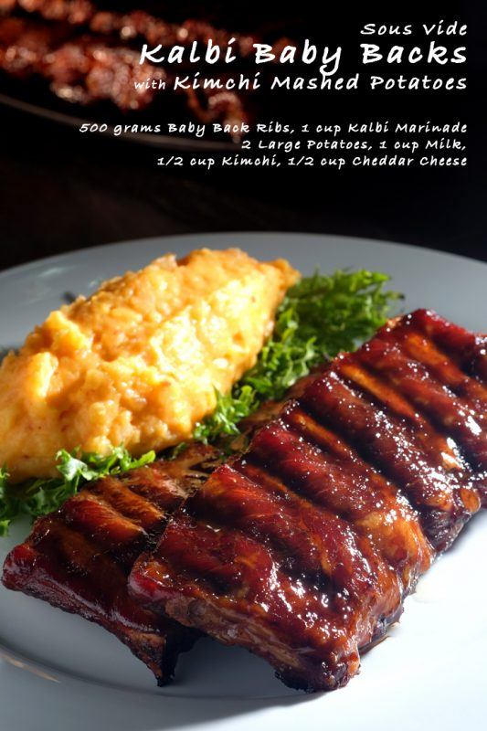 A gray plate containing sous vide kalbi baby backs that are served next to kimchi mashed potatoes and greens. 