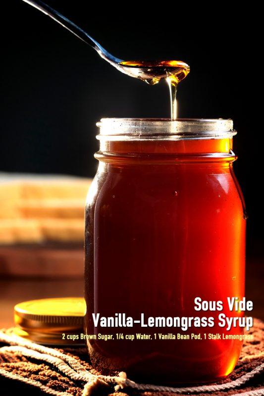 A jar containing a sous vide vanilla-lemongrass syrup infusion, with a single spoon of the syrup being scooped out.