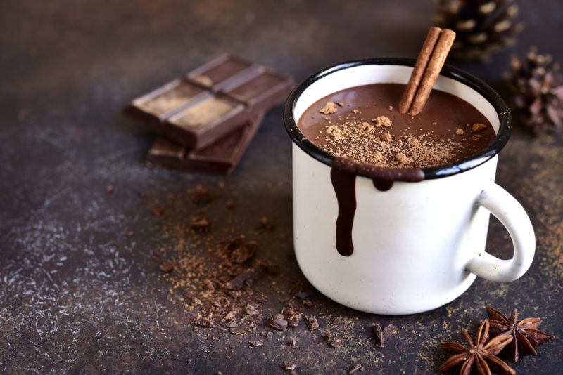 A hot chocolate ina mug with a cinnamon stick