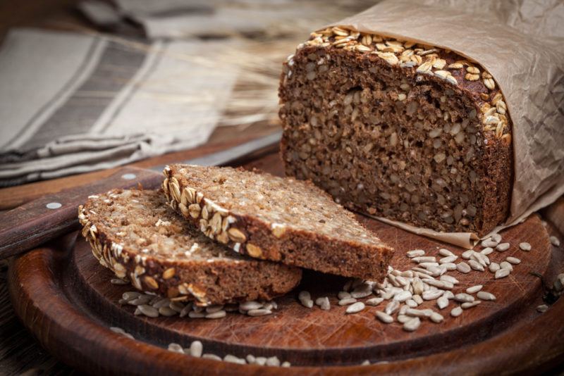 A loaf of sprouted bread with slives of bread