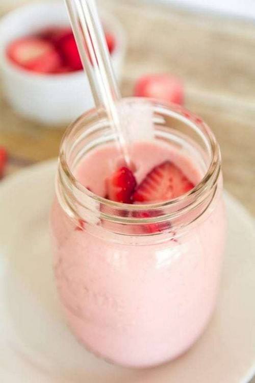 A light pink smoothie in a glass