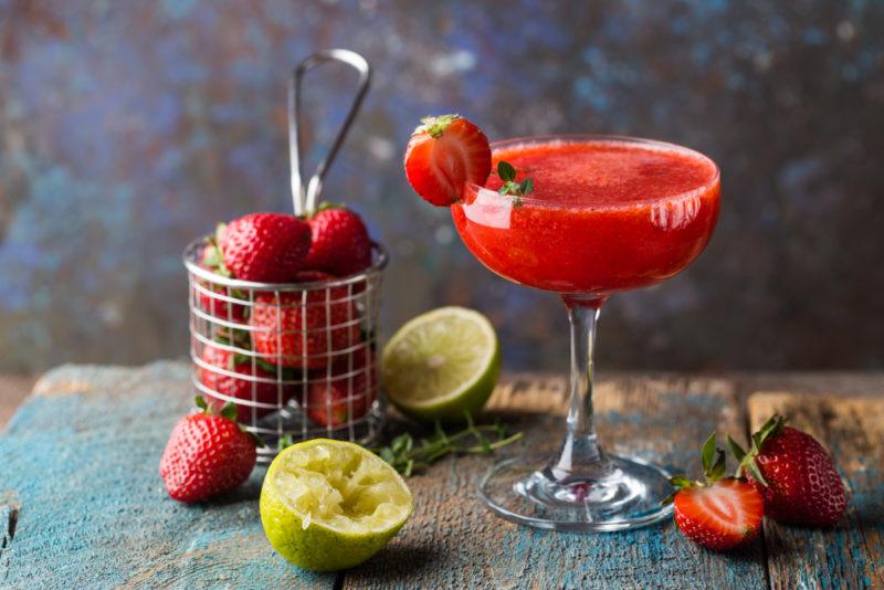 A strawberry daiquiri with strawberries in a basket