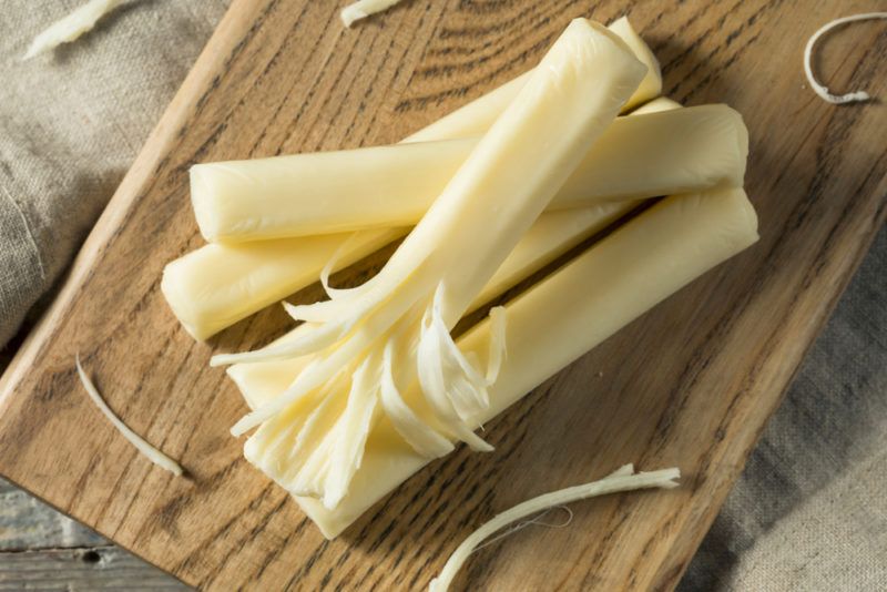 String cheese on a wooden board