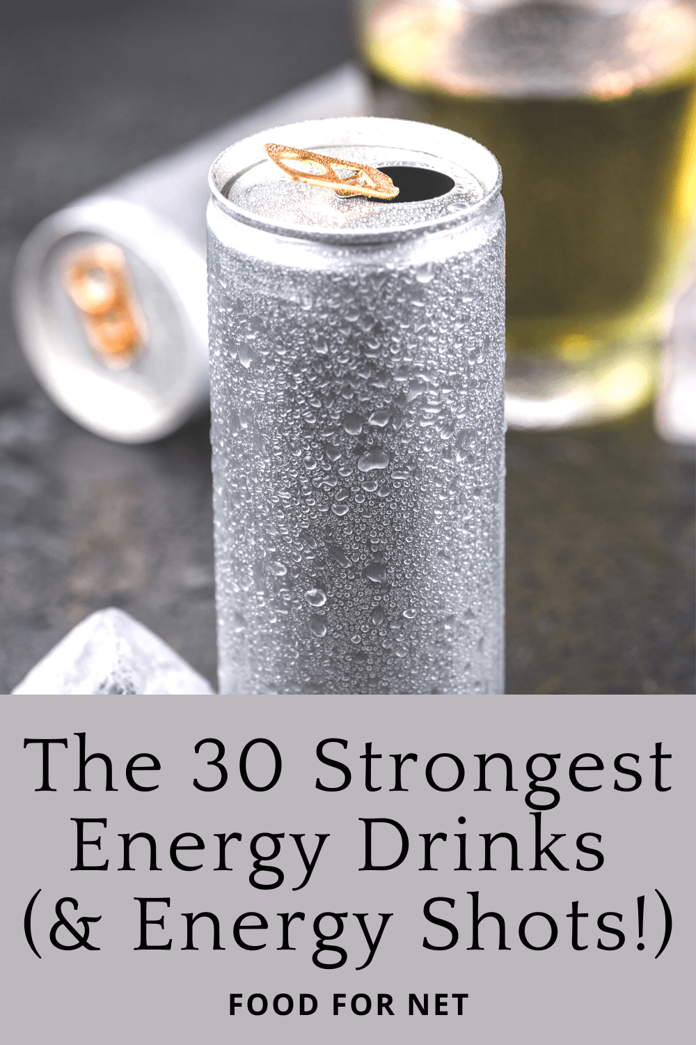 Strongest Energy Drinks. Silver cans of energy drink, with a glass of energy drink in the background