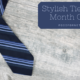 A blue and white striped tie on a gray wooden background