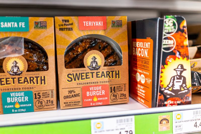 A grocery store shelf showing a few different Sweet Earth vegan products