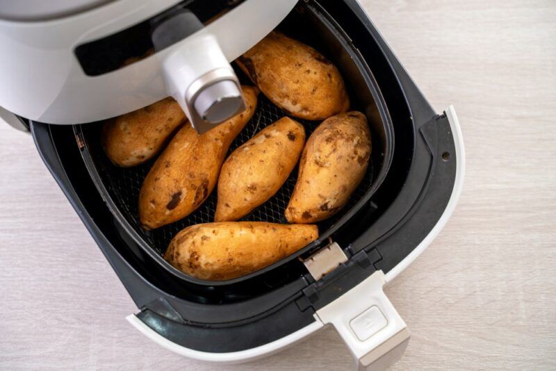 An open air fryer that contains sweet potatoes