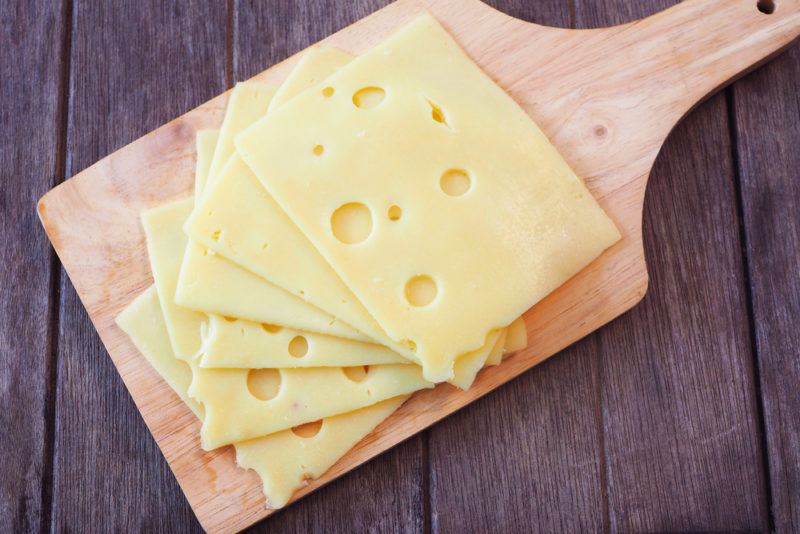 Swiss cheese on a wooden board