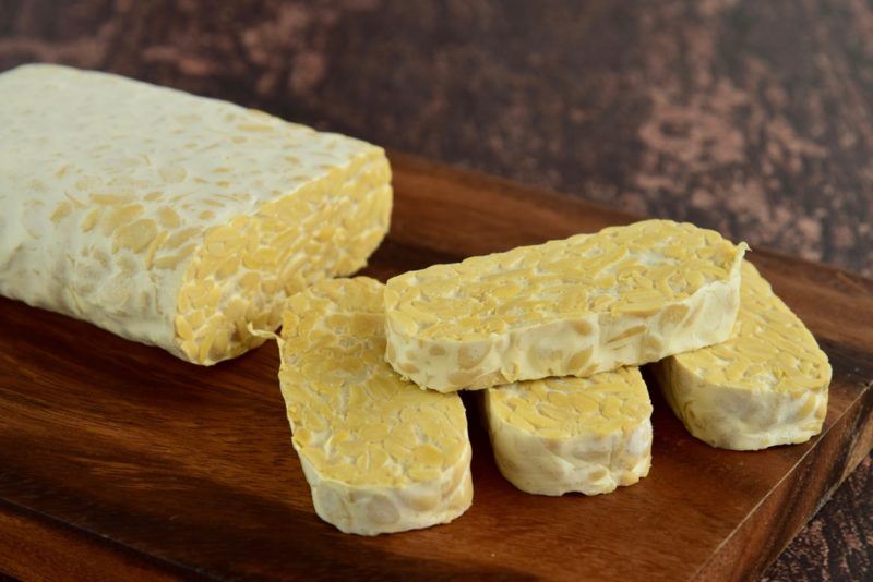 A loaf of tempeh with slices of tempeh