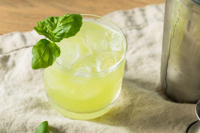 A Tequila Smash in a short cocktail glass with a basil leaf