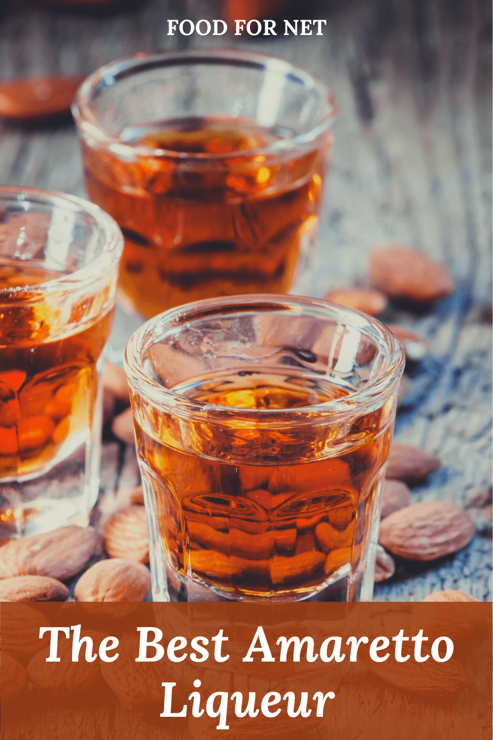 Multiple glasses of the best Amaretto liqueur on a table with almonds