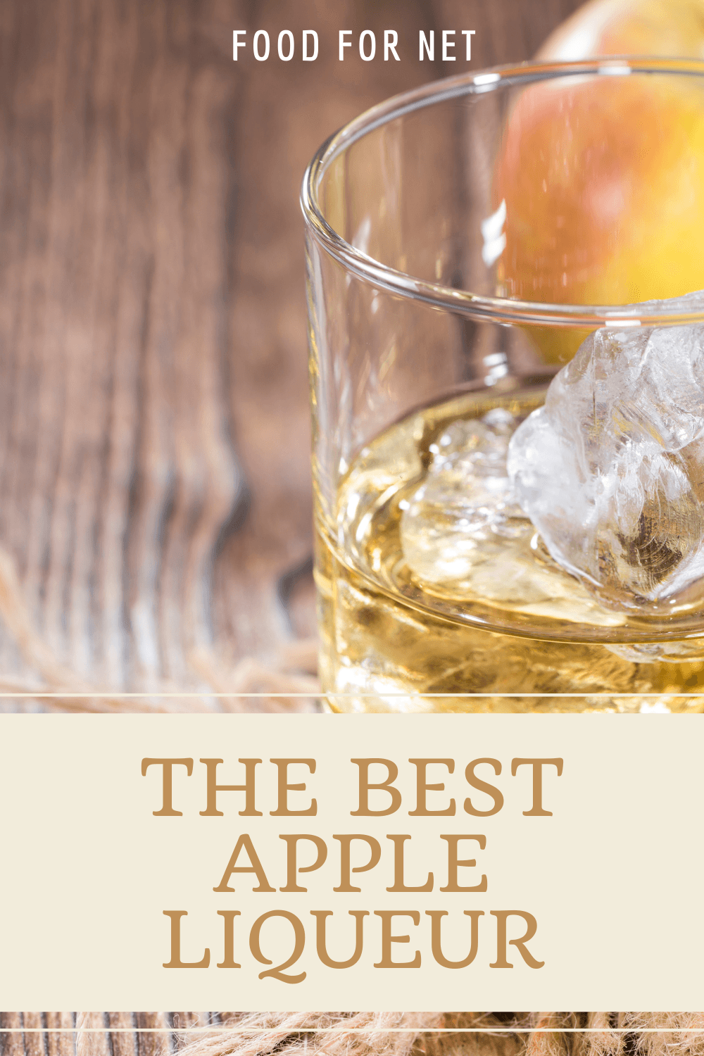 A glass of apple liqueur in front of apples