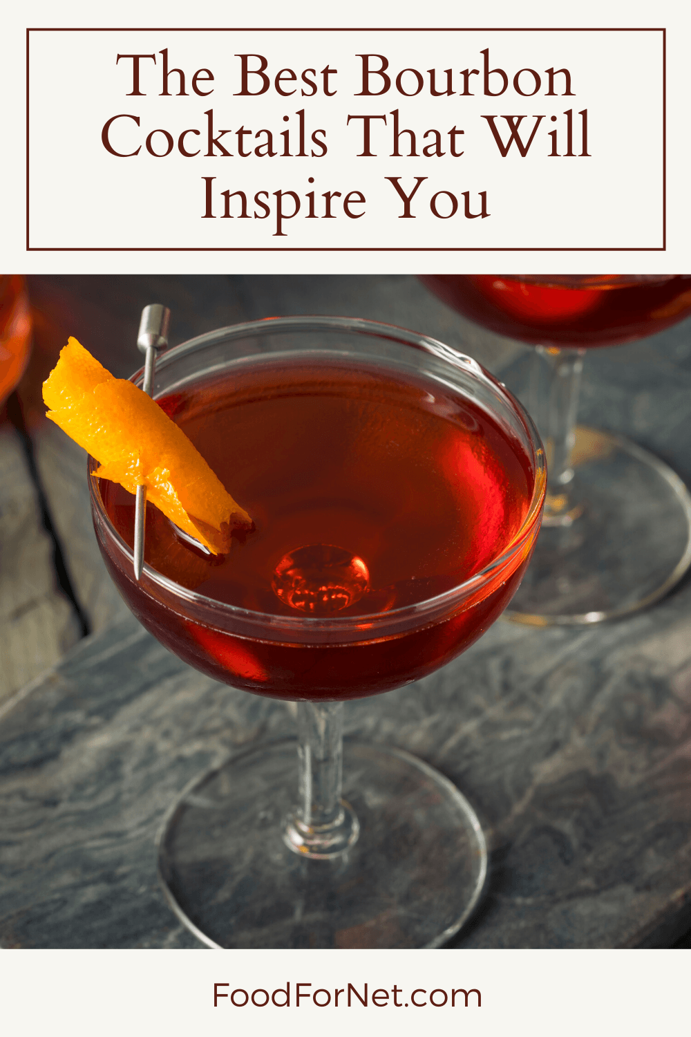 A bourbon cocktail on a slate table