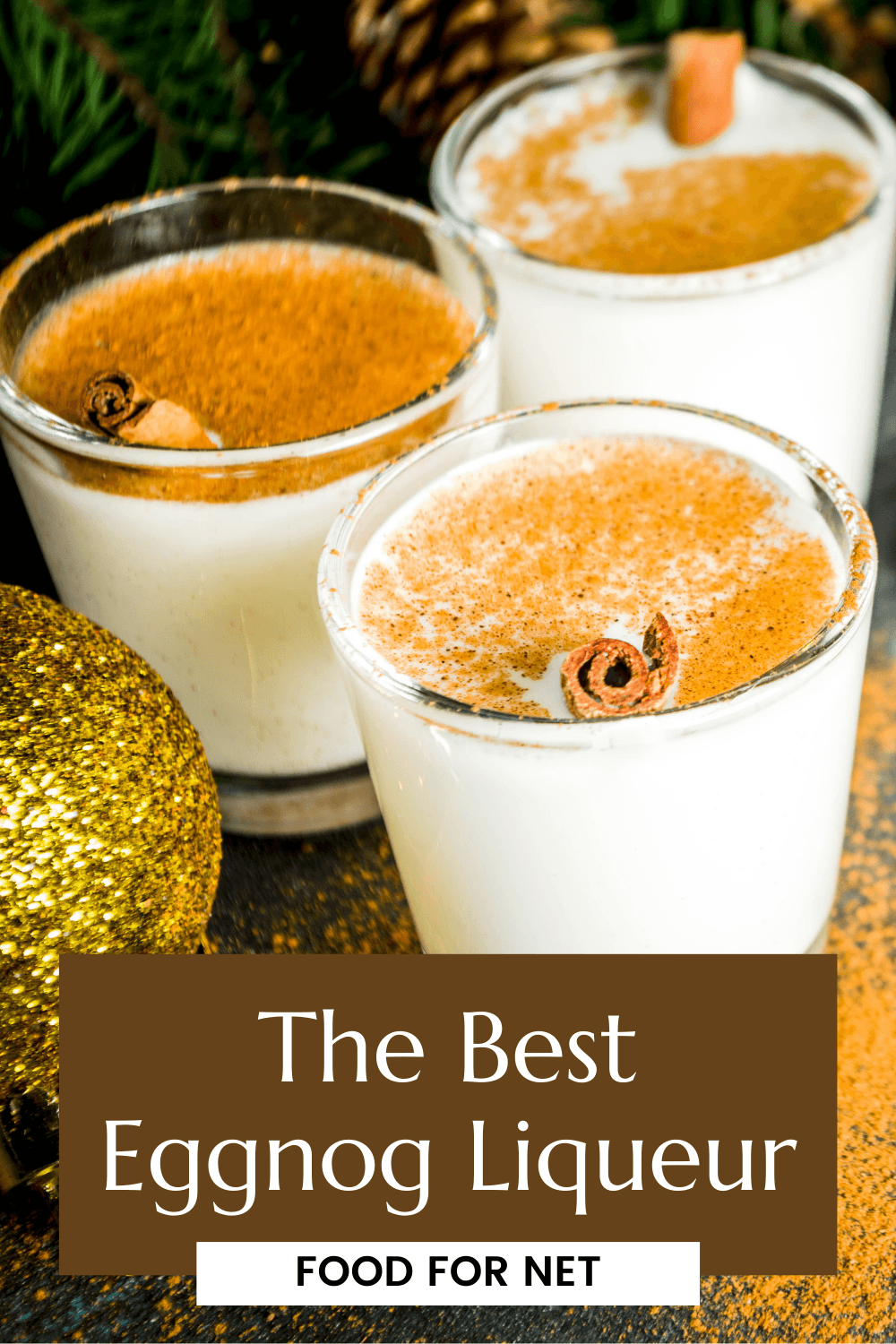 Best Eggnog Liqueur. Glasses of eggnog liqueur on a table with cinnamon and Christmas decorations