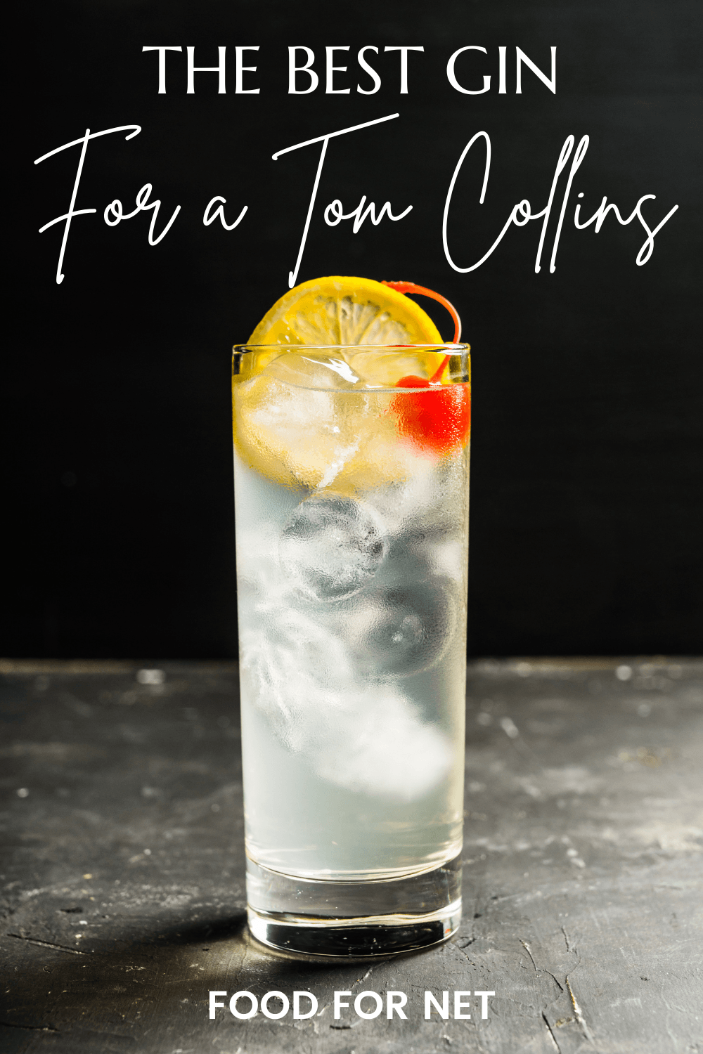 A glass of a Tom Collins cocktail with some citrus and a cherry