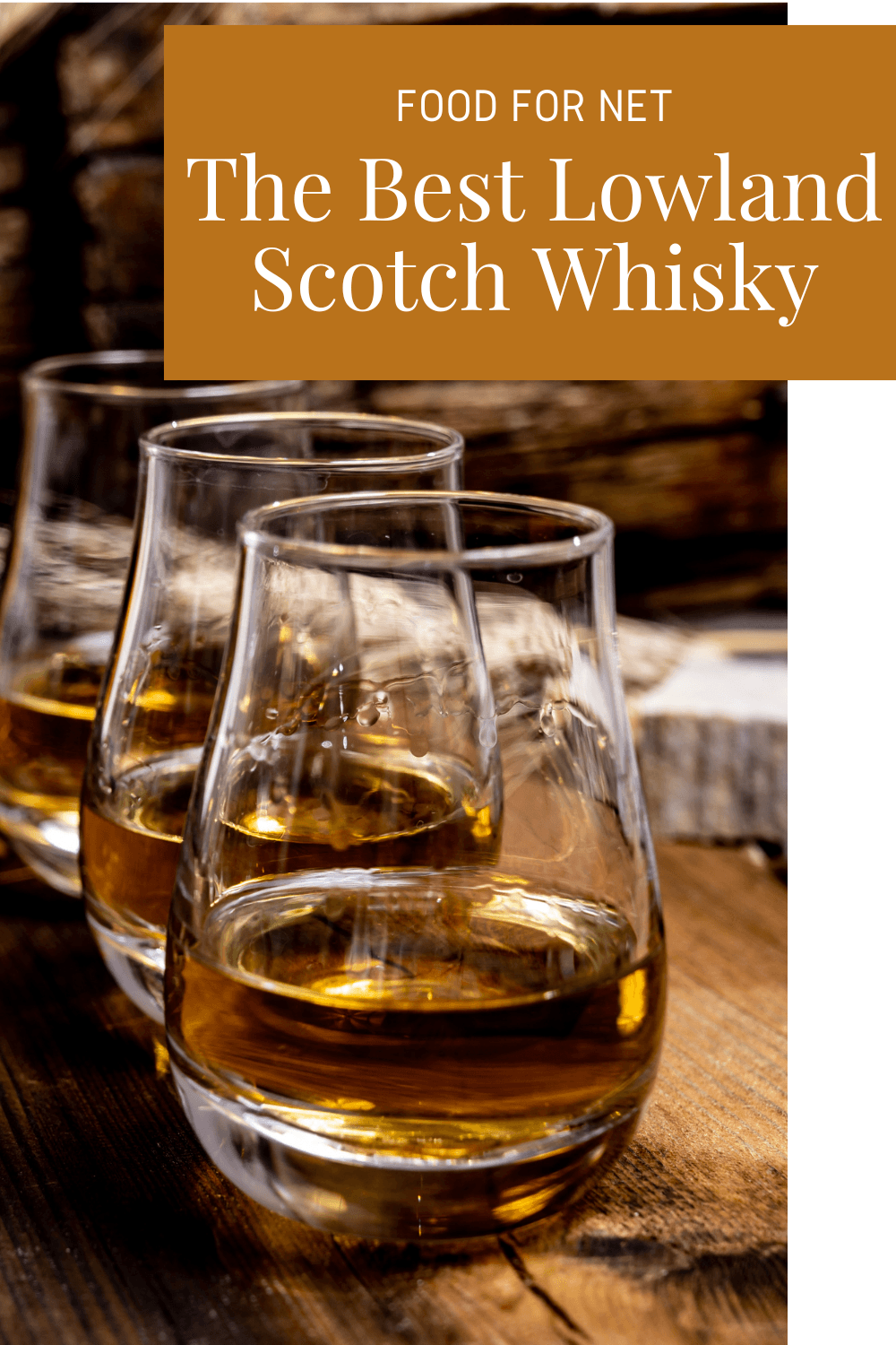 Three glasses of some of the best lowland Scotch whisky on a wooden bar