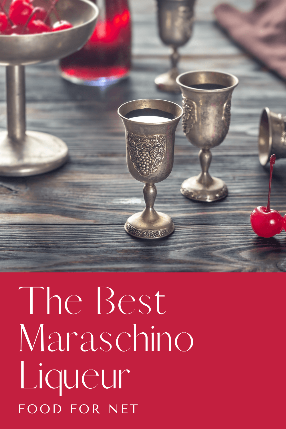 Silver goblets of the best maraschino liqueur on a table next to maraschino cherries