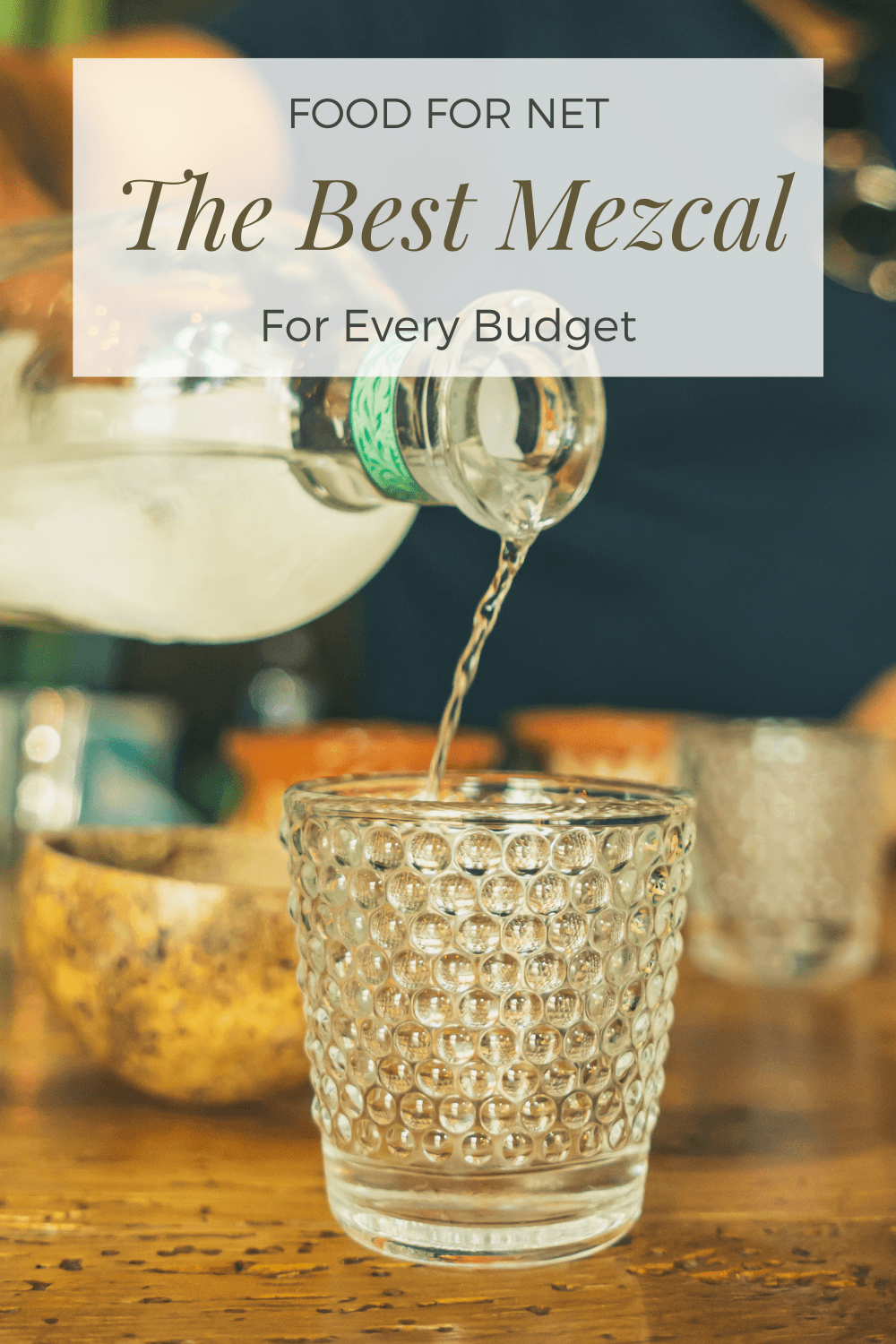 Mezcal being poured from a bottle into shot glasses