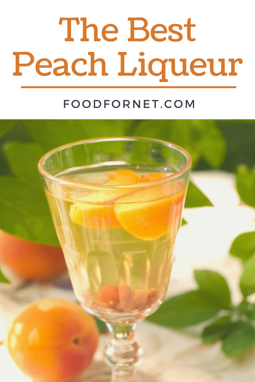 A glass of peach liqueur with peaches