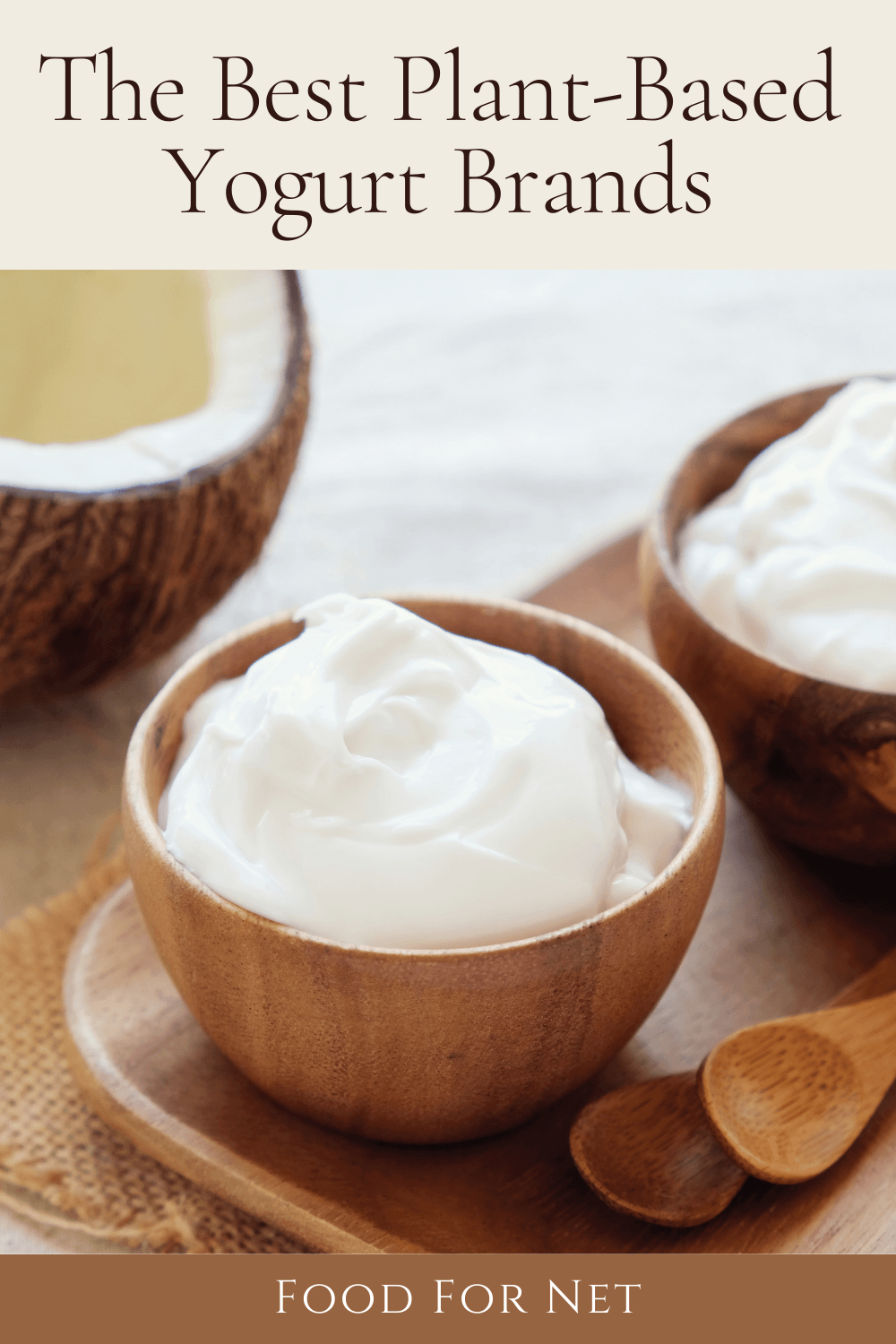 Two small bowls of coconut plant-based yogurt on a tray, next to a coconut