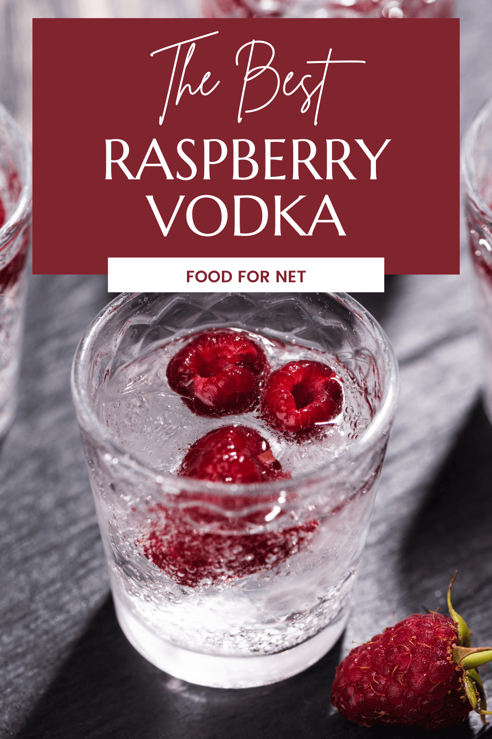 Glasses of vodka with raspberry on a black table, highlighting the idea of the best raspberry vodka