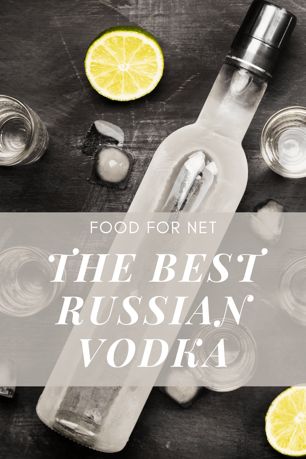 A bottle of Russia vodka on a black table, next to ice, shot glasses, and a lime