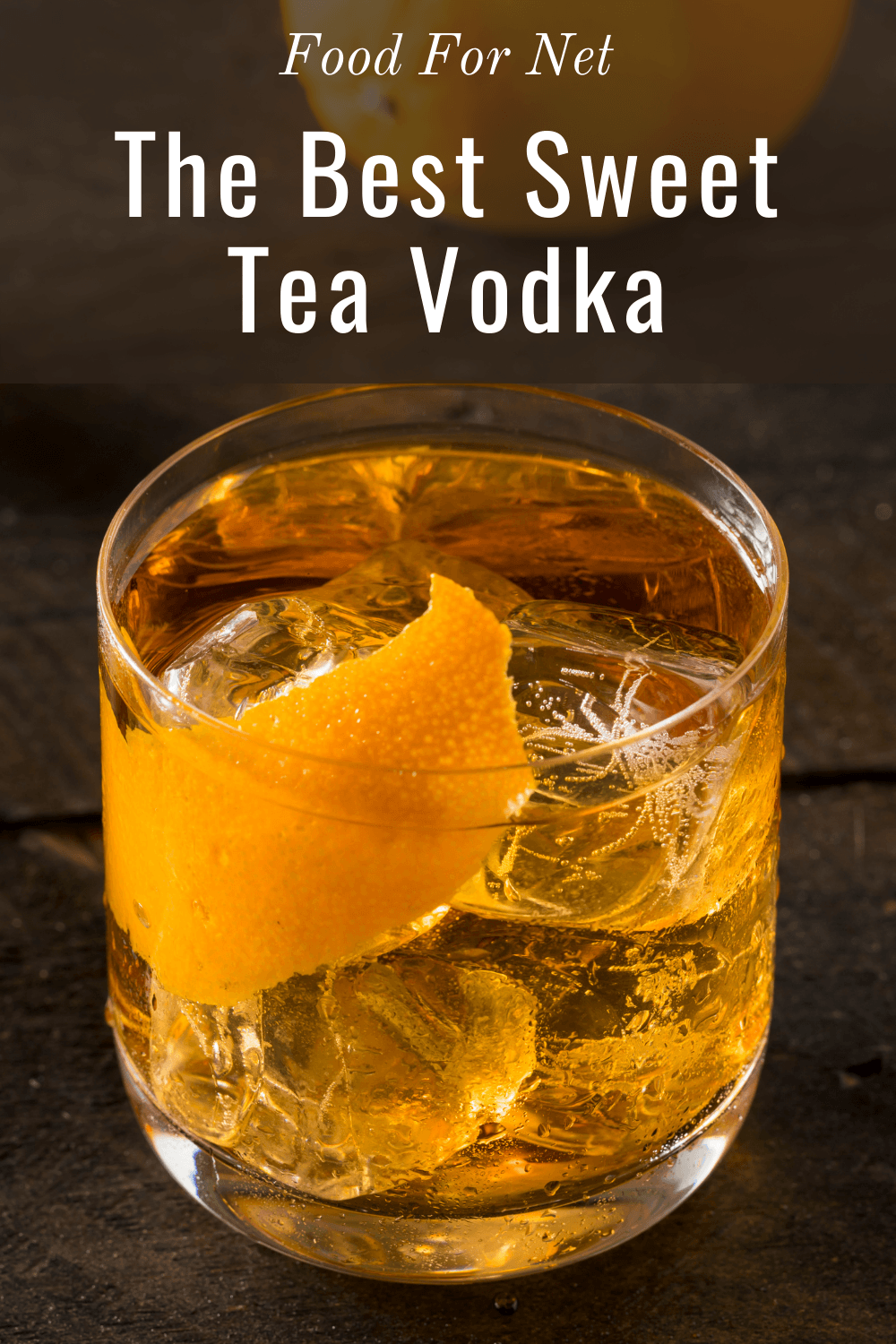 Glasses of sweet tea vodka on a dark wooden table, with a bottle of the vodka in the background