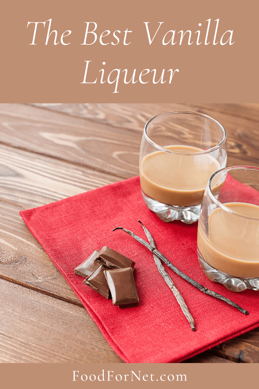 Two glasses of vanilla liqueur on a red cloth with vanilla beans and chocolate