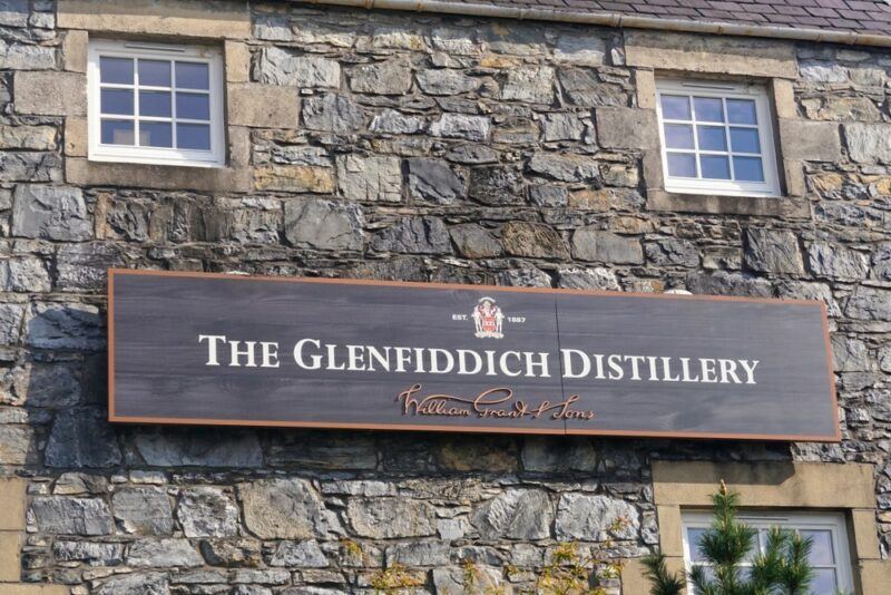 The Glenfiddich distillery with the sign attached to a old wall