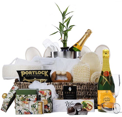 The Works Spa And Champagne Gift Basket | Food For Net Large basket with various spa-related items and wine.