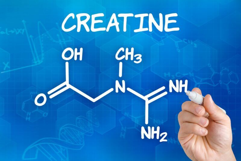 A light blue background, where someone is drawing the formula for creatine