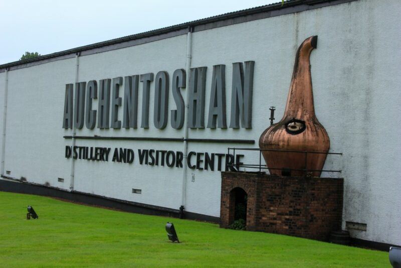 The visitor's center at the Auchentoshan distillery, with a still and the company's name on the side