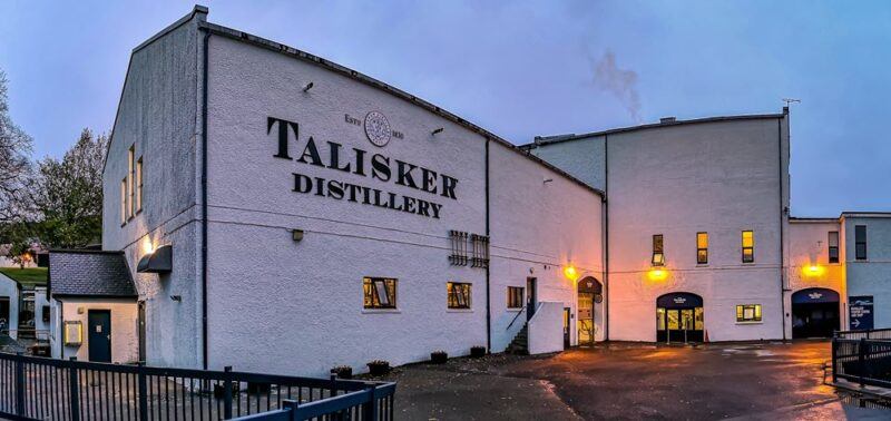 The Talisker distillery at twilight with its lights on