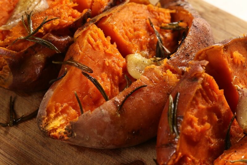 Three baked sweet potatoes that have been split open